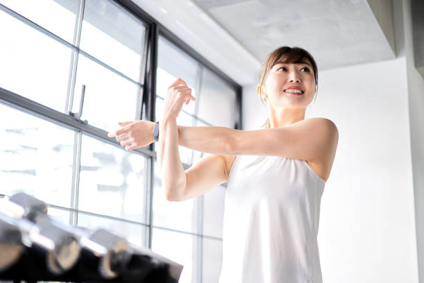Asian woman stretching in a training gym