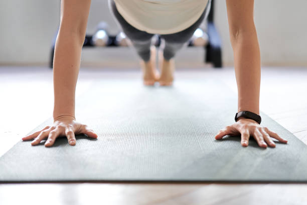 istock Asian woman doing push-ups in a training gym 1309541918