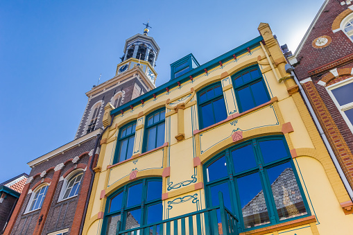Colorful old houses in front of the tower of Kampen, Netherlands