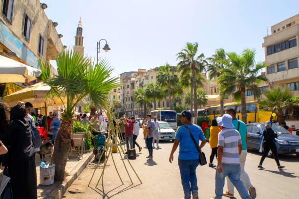Corniche street during feast time with many people. Crowded historical place with museums and mosque in Alexandria. stock photo