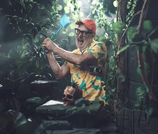Photo of Tourist trying to kill a spider in the forest