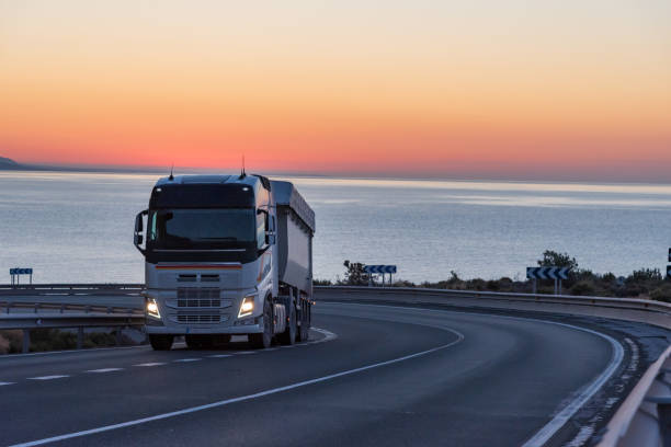 istock Dump truck on a mountain road 1309547385