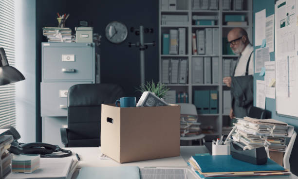 istock Box filled with personal belongings on the office desk 1309547589