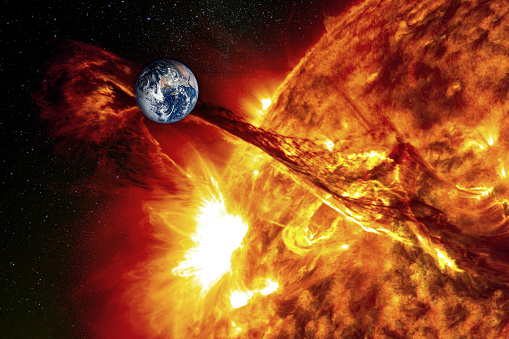 Planet Earth against the backdrop of a giant sun, the concept of solar activity, geomagnetic storm. The elements of this image furnished by NASA.

/urls:
https://images.nasa.gov/details-as17-148-22727.html
https://photojournal.jpl.nasa.gov/catalog/PIA23229
https://www.nasa.gov/feature/ames/solar-activity-forecast-for-next-decade-favorable-for-exploration
(https://www.nasa.gov/sites/default/files/thumbnails/image/cme_0.jpg)
https://solarsystem.nasa.gov/resources/429/perseids-meteor-2016/