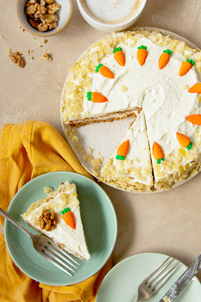 istock Carrot cake with walnuts an whipped cream, homemade easter cake baking, top view. Whole round cake. 1309549893