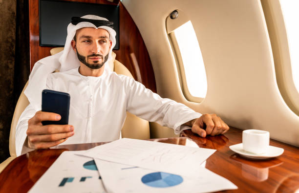 istock Arabian man wearing kandora flying on private jet 1309549914