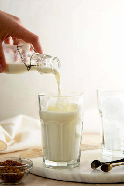 istock Dalgona coffee step by step recipe, pourring milk in glass. 1309550656
