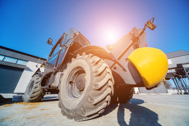 istock Big yellow forklift loader working near warehouse 1309552126