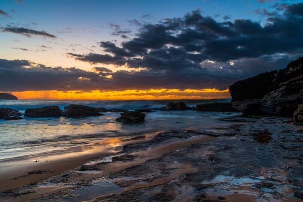 istock Sunrise seascape with rain clouds on the horizon 1309554134
