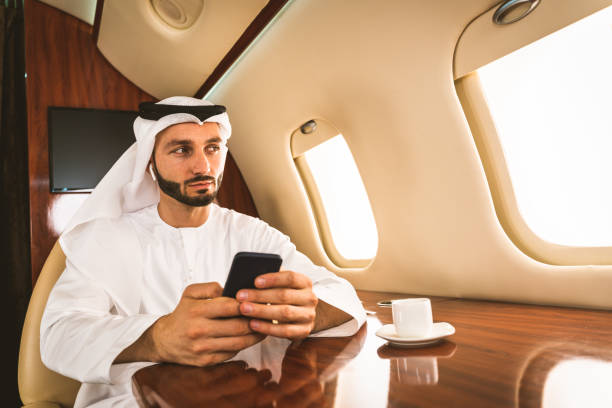 istock Arabian man wearing kandora flying on private jet 1309554247