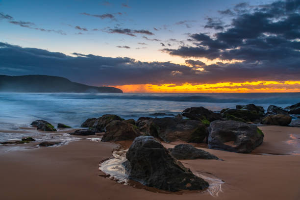 istock Sunrise seascape with rain clouds on the horizon 1309554248