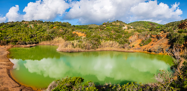 Terranera lake is a small, emerald green stretch of water of mineral origin located in the eastern side of Elba, the biggest island of the Tuscan Archipelago.  (4 shots stitched)