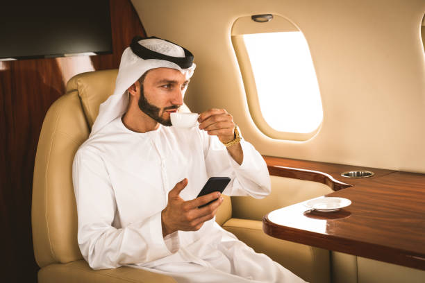Arabian man wearing kandora flying on private jet