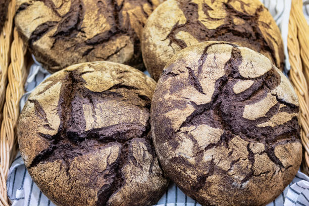 Loaves rye bread on shelf in market.