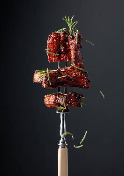 istock Grilled pork belly with rosemary on a fork. 1309558787