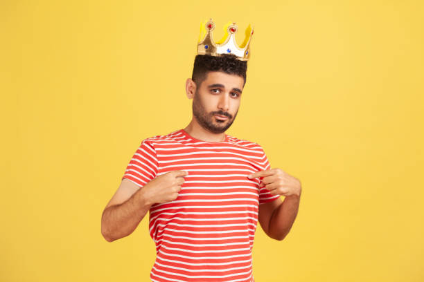 istock I'm king! Ambitious bearded man wearing golden crown and pointing himself, looking with arrogance, declaring his authority, superior privileged status 1309559048