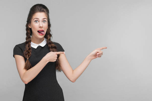 istock Crazy woman pointing finger at copy space. 1309559357