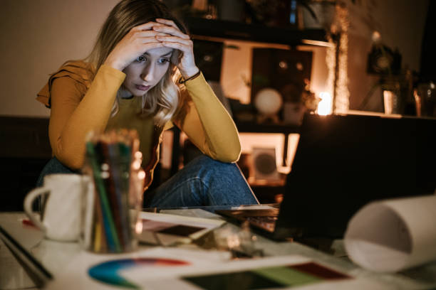 istock Sleepy woman working late at her home office 1309560277