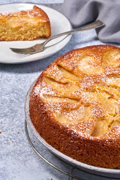 istock Freshly baked apple pie tart with custard filling on a rustic white background. Top view 1309560340