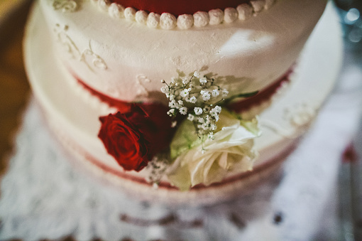 White Wedding Cake Decorated With Red Rose