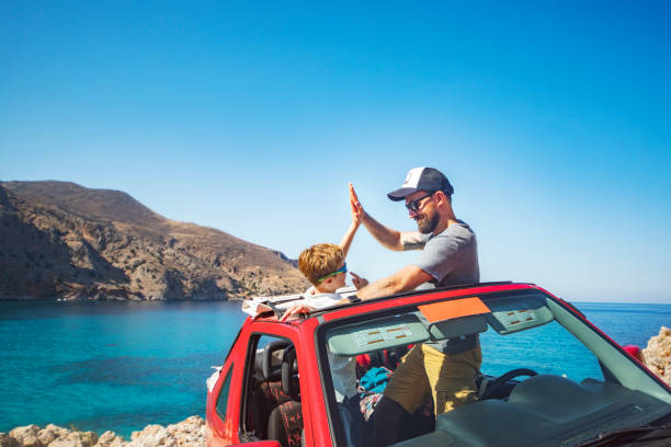 father and son sitting in the car at the beach - family beach cheerful happiness imagens e fotografias de stock