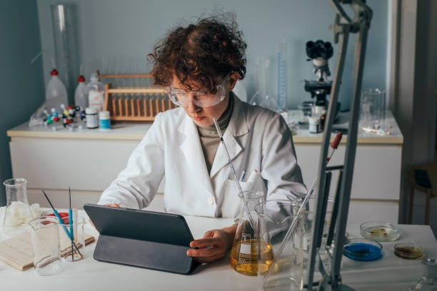 istock Woman Scientist in a Lab Coat Using a Digital Tablet During Research 1309560506