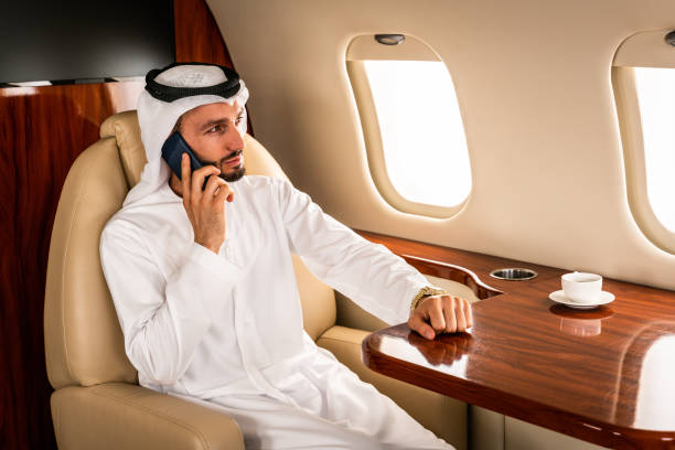 istock Arabian man wearing kandora flying on private jet 1309560824