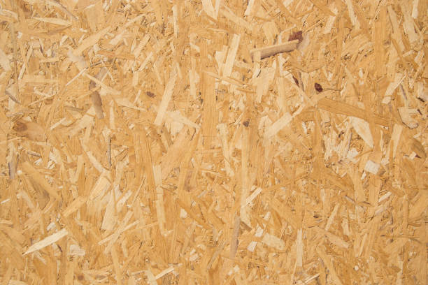 istock Wooden background, fiberboard or chipboard pattern, pressed wood shavings backdrop, wall made from wood 1309561502
