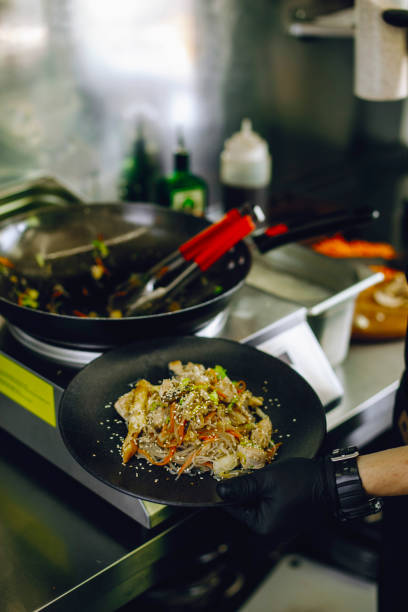 istock cooking vegan wok noodles with vegetables in cafe kitchen 1309562836