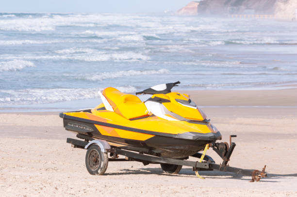 istock Jet ski on a boat trailer on a sandy beach 1309563003