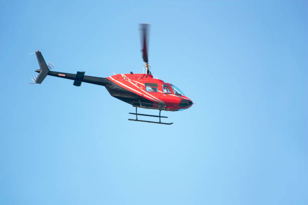 istock Red passenger helicopter on blue sky background 1309563053