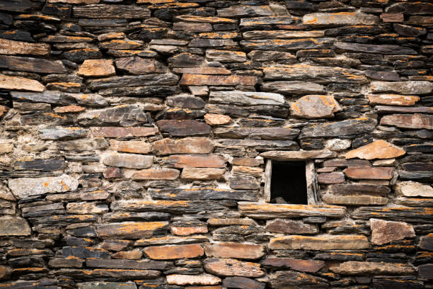 istock Side Of A Stone House With A Open Windows. 1309563338