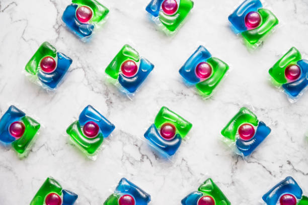 pattern of liquid Laundry Detergent Pod. Washing gel capsules close up.minimalism.Housework concept.laundry detergent on marble background liquid Laundry Detergent Pod. Washing gel capsules close up detergent capsule stock pictures, royalty-free photos & images