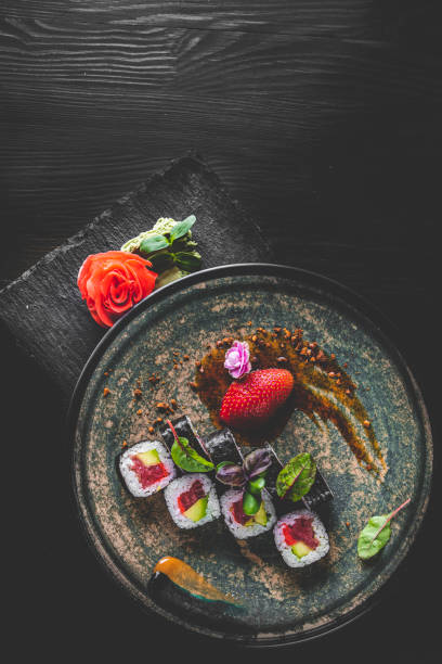 istock sushi roll in plate on wooden table background 1309565608
