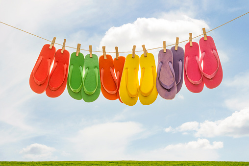 Gender party concept idea. Booties for baby girl or boy for first step. Knitted pink and blue booties on white fluffy blanket.