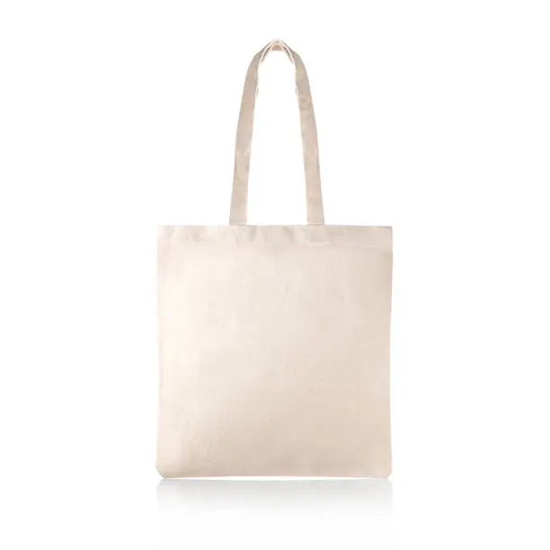 Photo of Blank Eco Friendly Beige Colour Fashion Canvas Tote Bag Isolated on White Background. Empty Reusable Bag for Groceries. Clear Shopping Bag. Design Template for Mock-up. Front View.