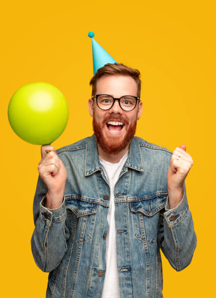 istock Cheerful young man with party accessories 1309569223