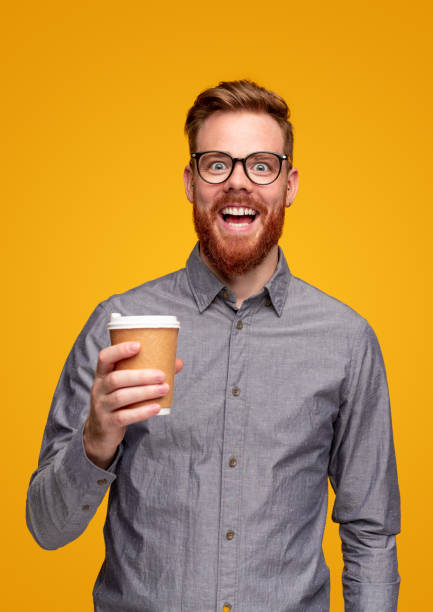 istock Excited bearded man with takeaway coffee 1309569244