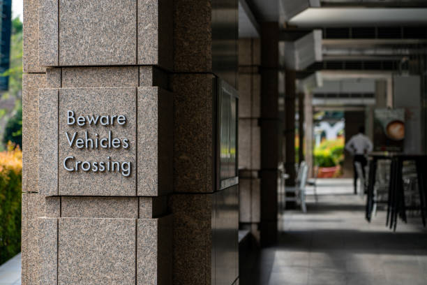 istock Beware Vehicles Crossing sign on the wall 1309570638