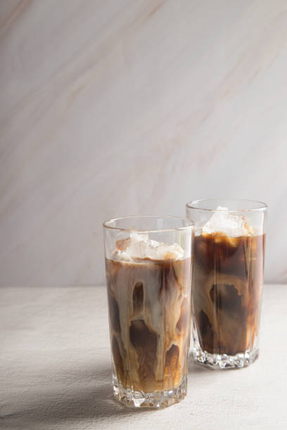 istock Cold sweet coffee with milk and ice on a light background. Copy space. 1309572300