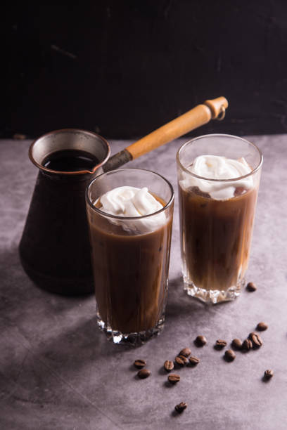 istock On a dark background, a coffee maker and glasses with cold iced coffee and whipped cream. Copy space. The concept of refreshing drinks for summer 1309573035