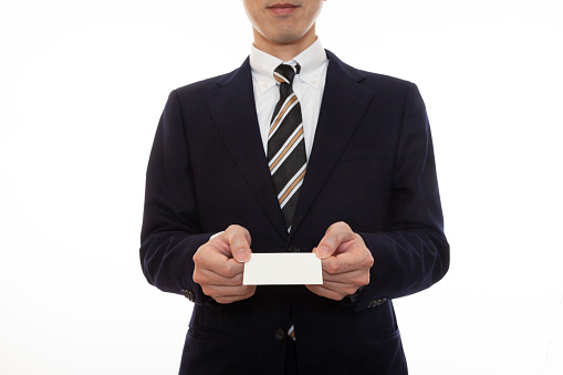 Business person holding a business card with both hands