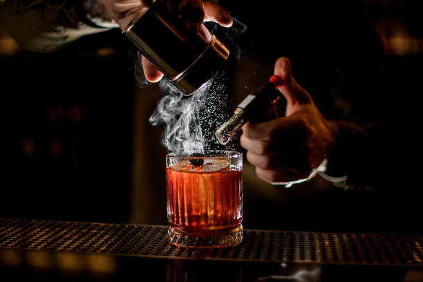 istock bartender carefully sprinkles icing sugar on steaming glass with alcoholic cocktail on the bar counter 1309574868