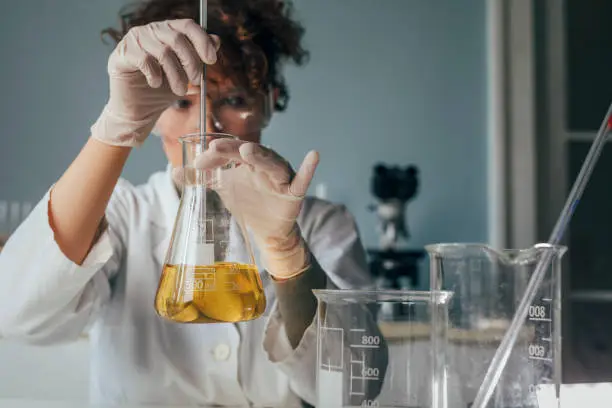 Women in science: a Caucasian woman performing tests at a laboratory