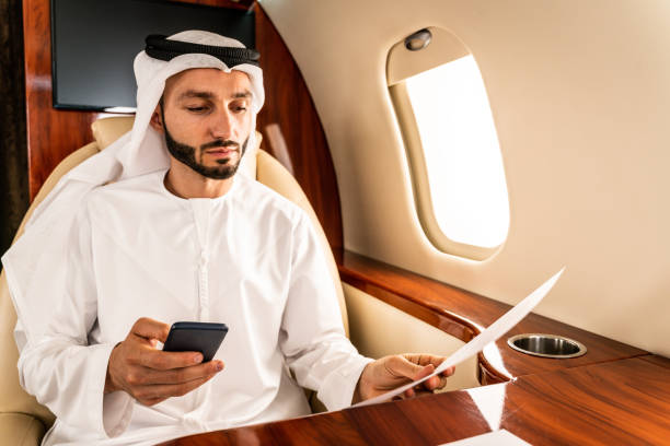 istock Arabian man wearing kandora flying on private jet 1309577528