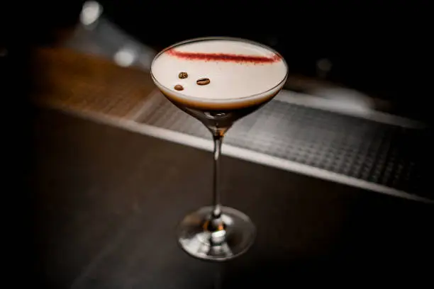 Photo of excellent view on glass with espresso martini cocktail decorated with coffee beans