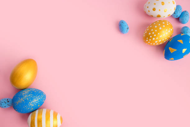 istock eggs golden and blue on modern beautiful pink paper 1309579005