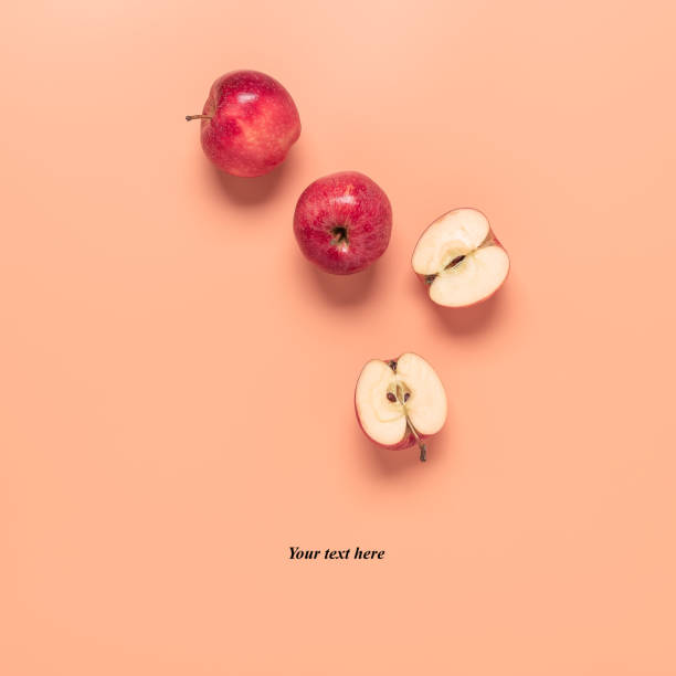 istock Red apples on a pastel pink background. Creative layout. Top view. 1309579573