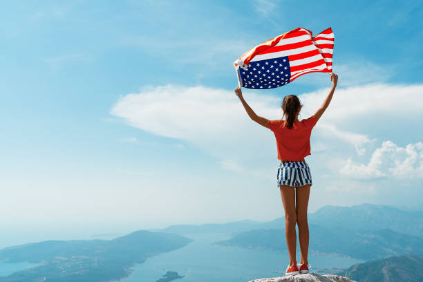 istock Girl is waving American flag 1309580159
