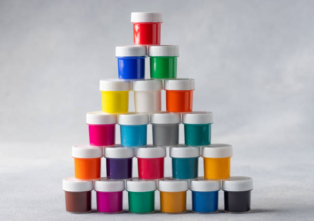 istock Pyramid of colorful gouache cans on gray background 1309580510